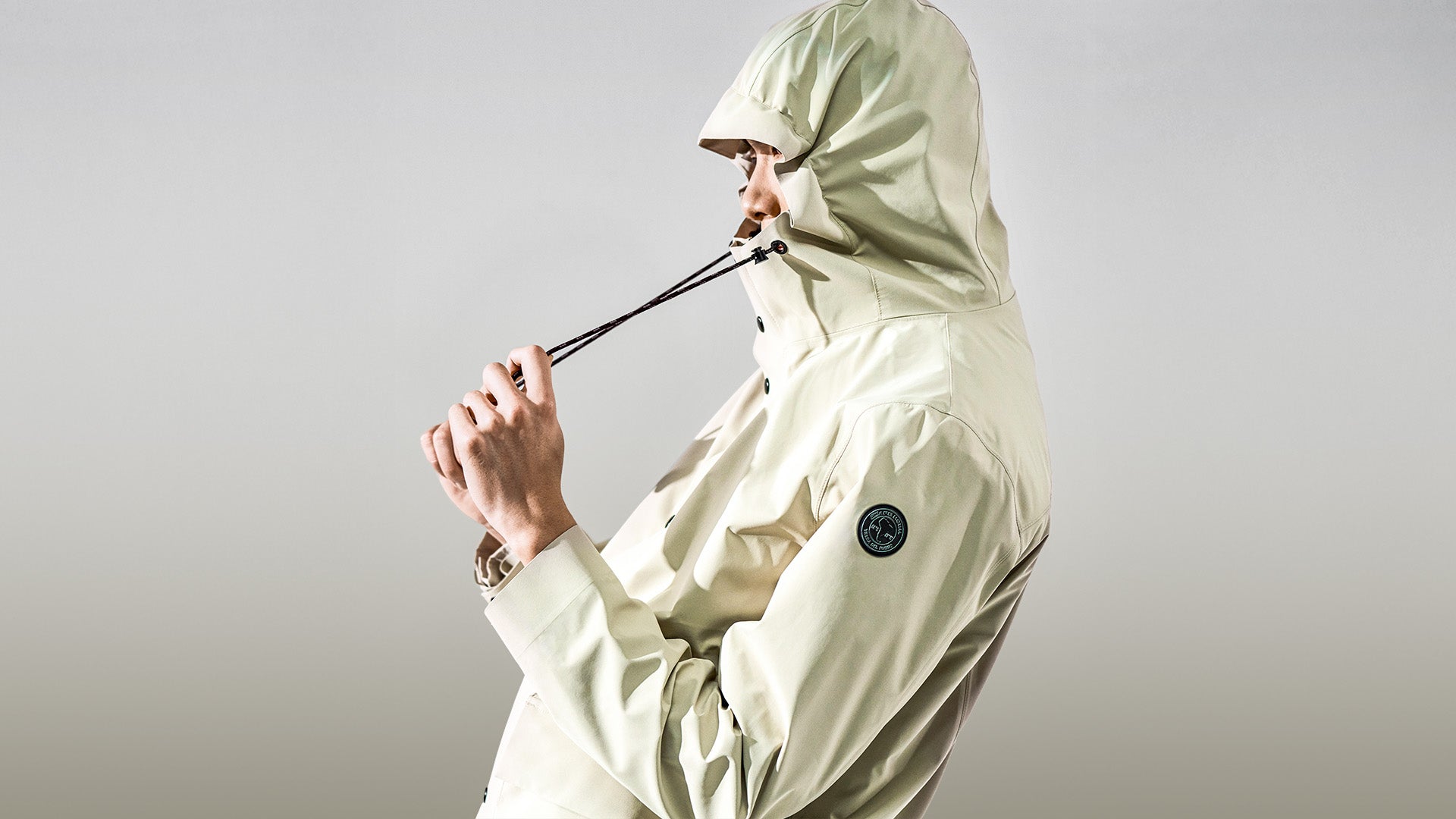 Uomo con giacca Weatherproof Cape Horn sotto cielo nuvoloso, abbigliamento resistente al vento e alla pioggia. - Cape Horn